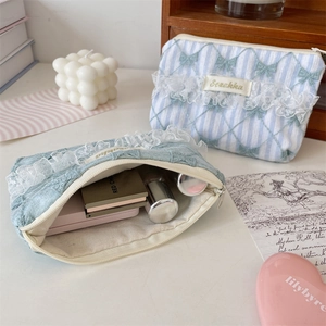 Lace floral pouches featuring bow embroidery and soft fabric ruffles for cosmetics