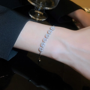 Detailed view of teardrop zircon bracelet with adjustable slider clasp on model wrist