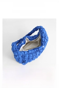 Detailed interior of blue quilted cloud bag showing large capacity for iPad and essentials