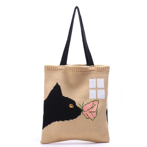 Minimalist knit tote bag with black cat jacquard pattern and sturdy handles on white back