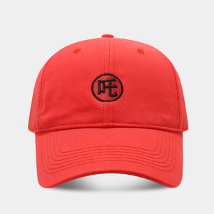Detailed view of red cotton baseball cap with black circular Chinese embroidery logo