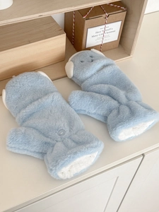 Close-up of light blue plush convertible mittens with thick faux lamb wool lining and button