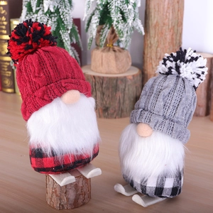 Christmas gnome plush ornaments set with knit hats and wooden skis on a wooden base