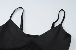 Detail shot of the V-neckline and adjustable spaghetti straps on a black mesh summer dress