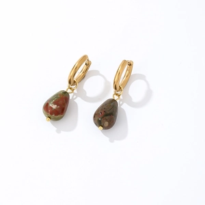 Detail of teardrop natural gemstone earrings with gold hoop and red-green textures