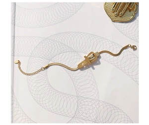 Detailed close-up of 18K gold snake chain bracelet with belt buckle clasp design
