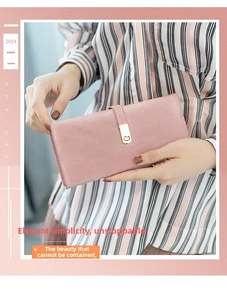 Close-up of pink long leather wallet with metal buckle clasp held by a model