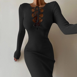 Detail of black ribbed knit dress featuring a criss-cross lace-up cutout on the chest