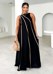 Detail of loose sleeveless dress in black fabric with beige diagonal stripe patterns