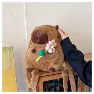 Close-up of brown plush capybara backpack featuring a cute pink flower accessory detail
