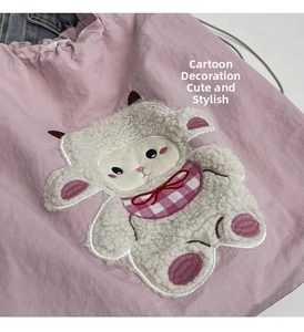 Close-up of pink canvas tote bag featuring a cute 3D cartoon sheep patch and drawstring