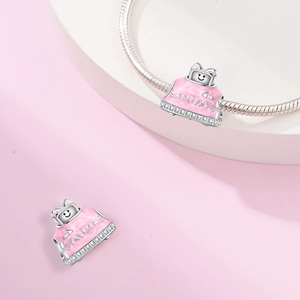 Detailed close-up of pink enamel holiday charm with zircon inlay for DIY charm bracelets