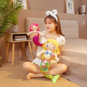 Cute mermaid plush dolls with colorful fishtails shown in a cozy bedroom setting