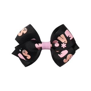 Detailed view of handmade Halloween hair clip with pink floral prints on black ribbon