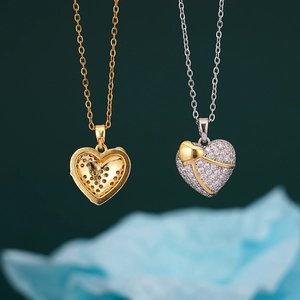 Classic 18K gold and silver heart pendant necklace set with pavé cubic zirconia