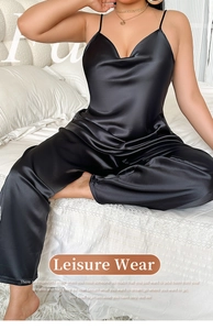 Detail view of black silk satin two-piece sleepwear set with camisole and pants