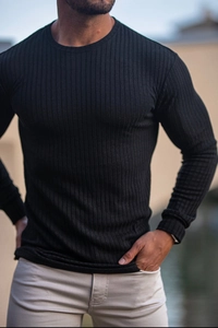Detail of men's slim fit black ribbed knit long sleeve t-shirt with crew neck finish