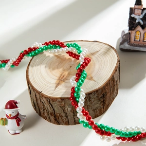 Handcrafted Christmas woven twist necklace with red, green, and white imitation pearls