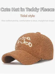 Detailed macro shot of brown teddy fleece baseball cap with white embroidery