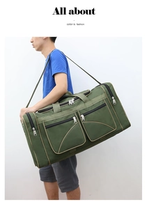 Man carrying large green canvas travel duffel bag with brown trim over shoulder detail
