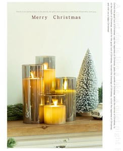 Set of four gradient smoke gray glass LED candles with warm light and festive decor
