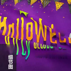 Detail of Halloween tapestry with purple fabric texture and artistic orange lettering