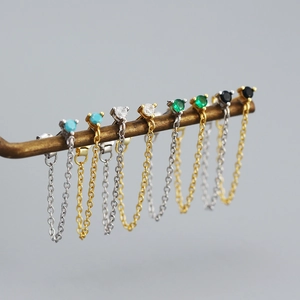 Macro view of S925 silver fringe stud earrings featuring colorful gemstones and chains