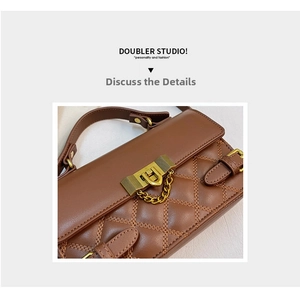 Close-up of brown quilted leather handbag featuring vintage gold lock and chain detail