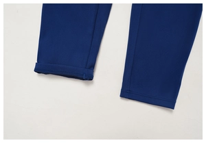 Detailed close-up of dark blue yoga leggings hem showing precise stitching and texture