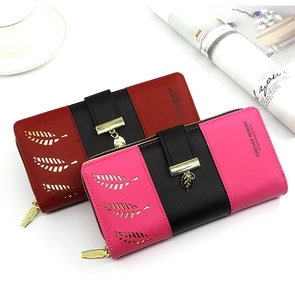 Detail of red and rose pink bifold wallets with leaf hollow pattern and metal pendant