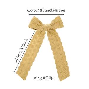 Lace swallowtail bow hair clip in yellow with floral crochet texture and long ribbons