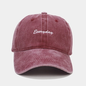 Detail of burgundy washed cotton baseball cap with white Everyday script embroidery