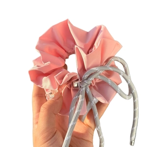 Pink checkered bow scrunchie with grey braided rope detail on a white background