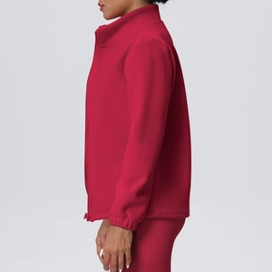 Close-up detail of red high collar fleece sports jacket showing zipper and warm texture