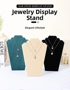Three jewelry neck busts in green velvet, beige linen, and black velvet for necklaces