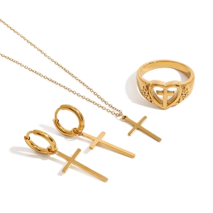 Golden stainless steel jewelry set with cross necklace, heart ring, and earrings