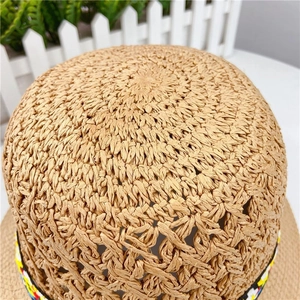 Handmade woven straw sun hat with floral ribbon and breathable hollow mesh crown design