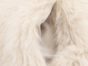 Detail of light beige faux fur vest showing plush texture and smooth silk-like lining