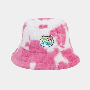 Detail of pink tie-dye plush bucket hat showing soft faux fur texture and sea breeze patch
