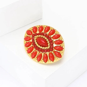 Elegant gold Turkish brooch with red oval crystal and rhinestones on white display