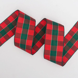 Close-up of Christmas plaid ribbon featuring red and green woven texture and gold stripes