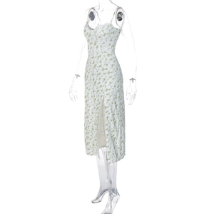 Detail view of floral midi slip dress featuring a side slit and green flower pattern