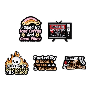 Set of five orange enamel pins featuring iced coffee slogans and metal badge designs