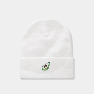 Detailed close-up of white knitted beanie with high-quality avocado embroidery