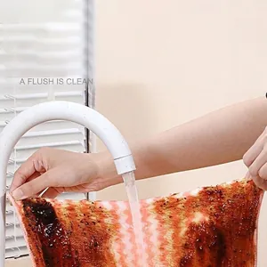 Absorbent coral fleece cleaning cloth with wave stripes showing easy oil removal under water