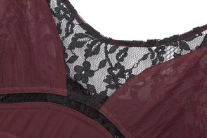 Detailed close-up of delicate black floral lace trim on a wine red sleeveless dress