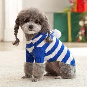 Detailed knit texture and pom-pom hood on a blue and white striped dog sweater