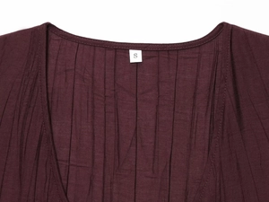 Detailed macro view of the dark red wrinkled texture fabric and V-neckline on size S top