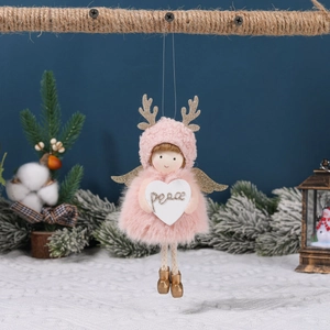 Pink plush Christmas angel ornament with golden antlers and heart sign saying Peace