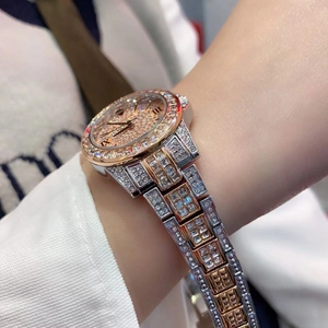 Close-up of luxury women watch with rhinestone pavé dial and two-tone metal strap